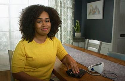 woman measuring blood pressure at home