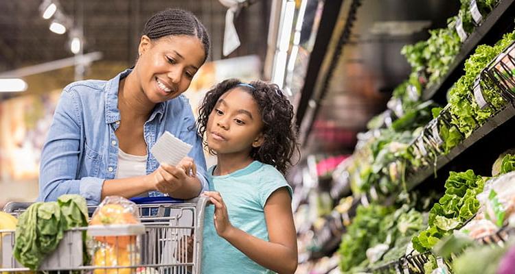 Mother and daughter grocery shopping