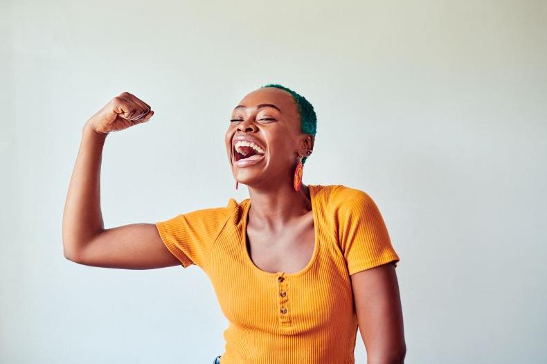 African American woman flexing arm muscle