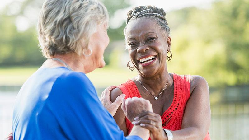 happy multi ethnic woman holding hands