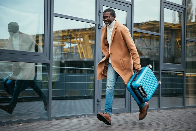 passenger at airport running with suitcase