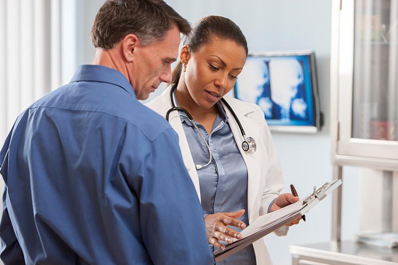 man talking to woman doctor