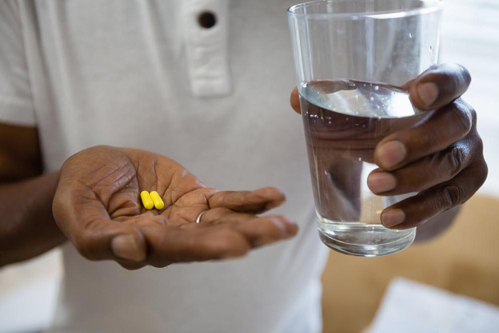 man holding pills