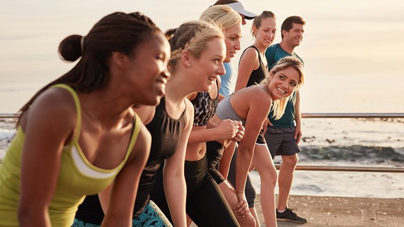 Group of multi-ethnic young adults starting a race on the beach