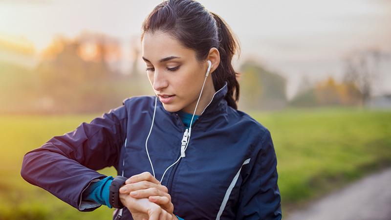 female runner checking watch