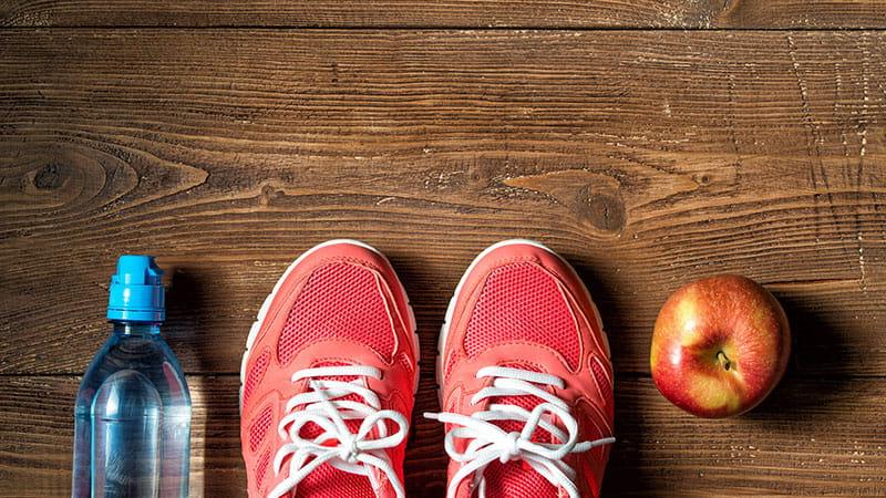 Sneakers, apple and water bottle